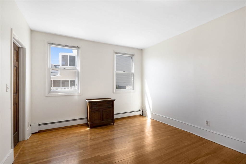 18 Briggs Street Salem, MA 01970 - Photo 19 of 43 a view of an empty room with wooden floor and a window