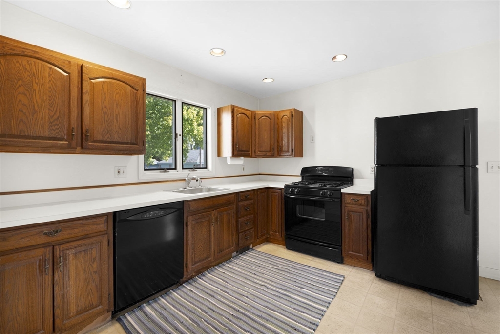 18 Briggs Street Salem, MA 01970 - Photo 20 of 43 a kitchen with a sink stove and refrigerator