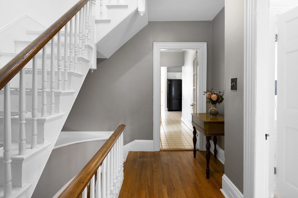 18 Briggs Street Salem, MA 01970 - Photo 23 of 43 a view of a hallway with wooden floor and staircase