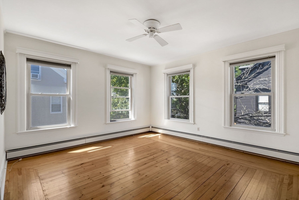 18 Briggs Street Salem, MA 01970 - Photo 24 of 43 a view of an empty room with wooden floor and a window