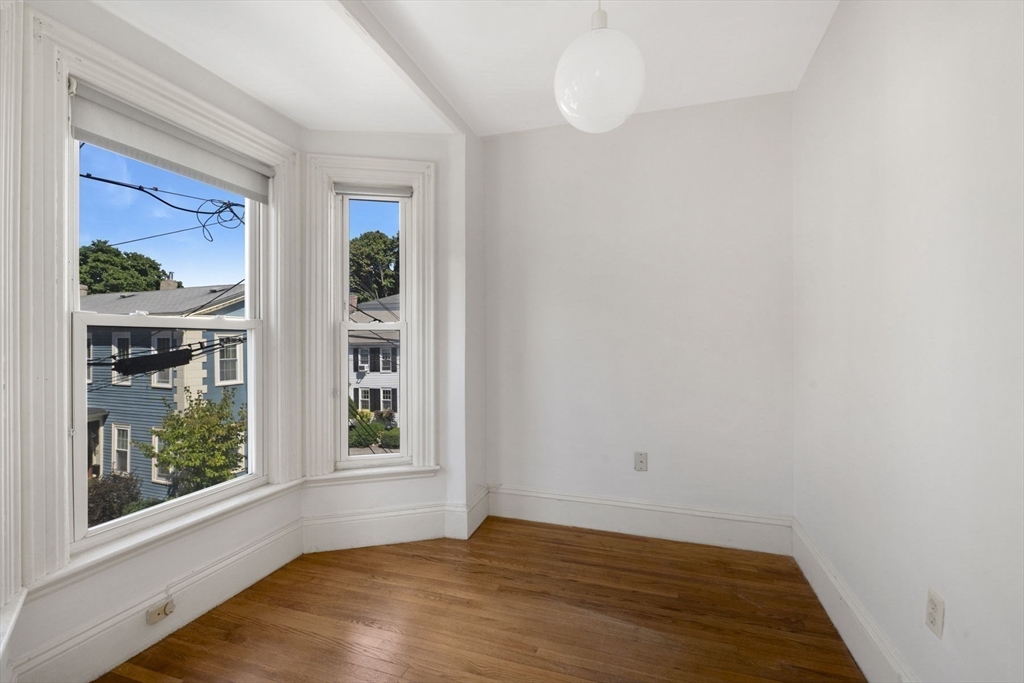 18 Briggs Street Salem, MA 01970 - Photo 26 of 43 a view of an empty room with window and wooden floor
