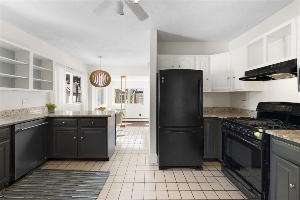 18 Briggs Street Salem, MA 01970 - Photo 31 of 43 a kitchen with granite countertop a refrigerator stove top oven and sink