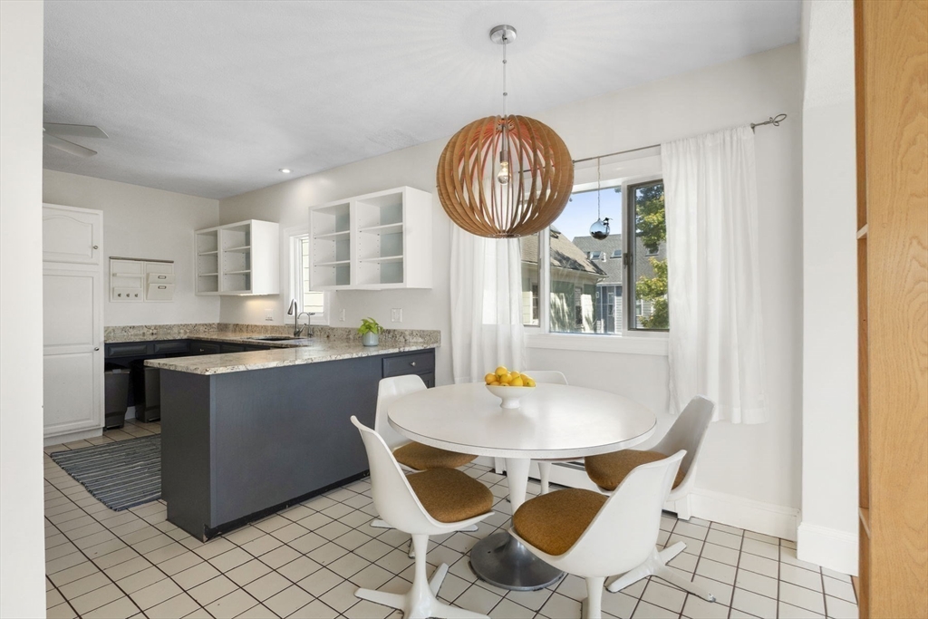 18 Briggs Street Salem, MA 01970 - Photo 32 of 43 a kitchen with a dining table and chairs