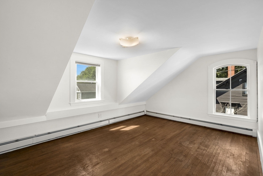 18 Briggs Street Salem, MA 01970 - Photo 38 of 43 an empty room with wooden floor and windows