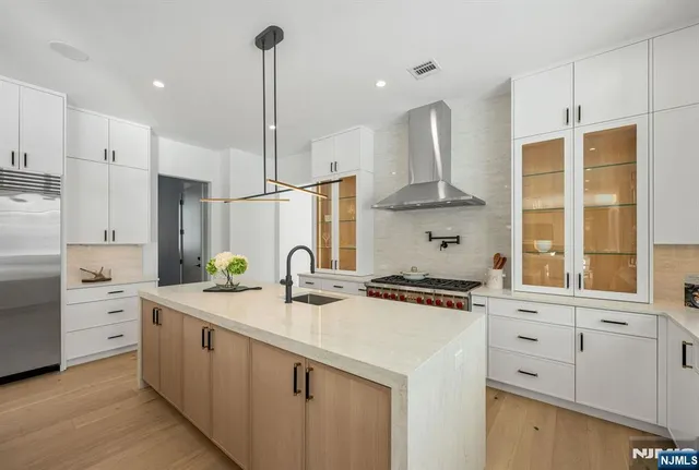 a spacious bathroom with a bathtub sink and mirror