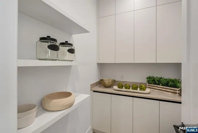 a living room with furniture a rug and a flat screen tv