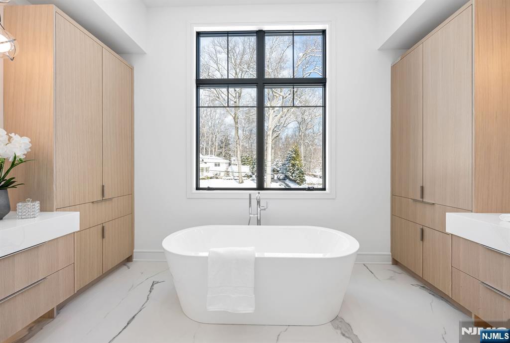 48 Brook Road Upper Saddle River, NJ 07458 - Photo 31 of 50 a white bath tub sitting in a bathroom next to a window