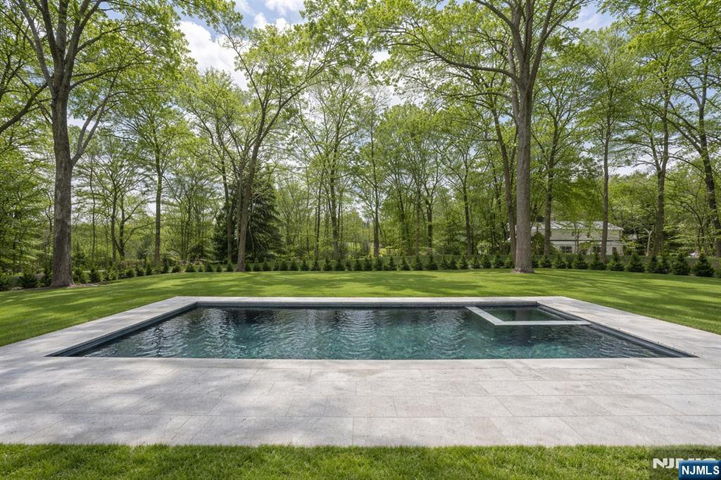 48 Brook Road Upper Saddle River, NJ 07458 - Photo 50 of 50 a view of a swimming pool with a yard