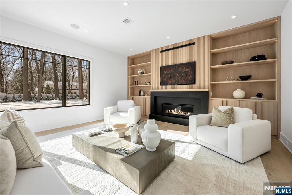 48 Brook Road Upper Saddle River, NJ 07458 - Photo 7 of 50 a living room with furniture a flat screen tv and a fireplace