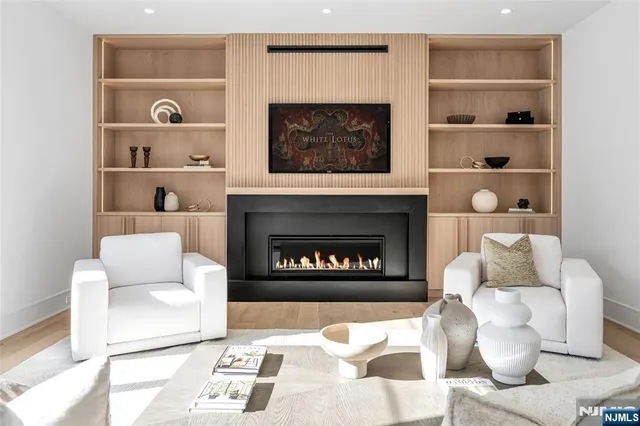 a kitchen with stainless steel appliances granite countertop a sink a stove and a wooden floors