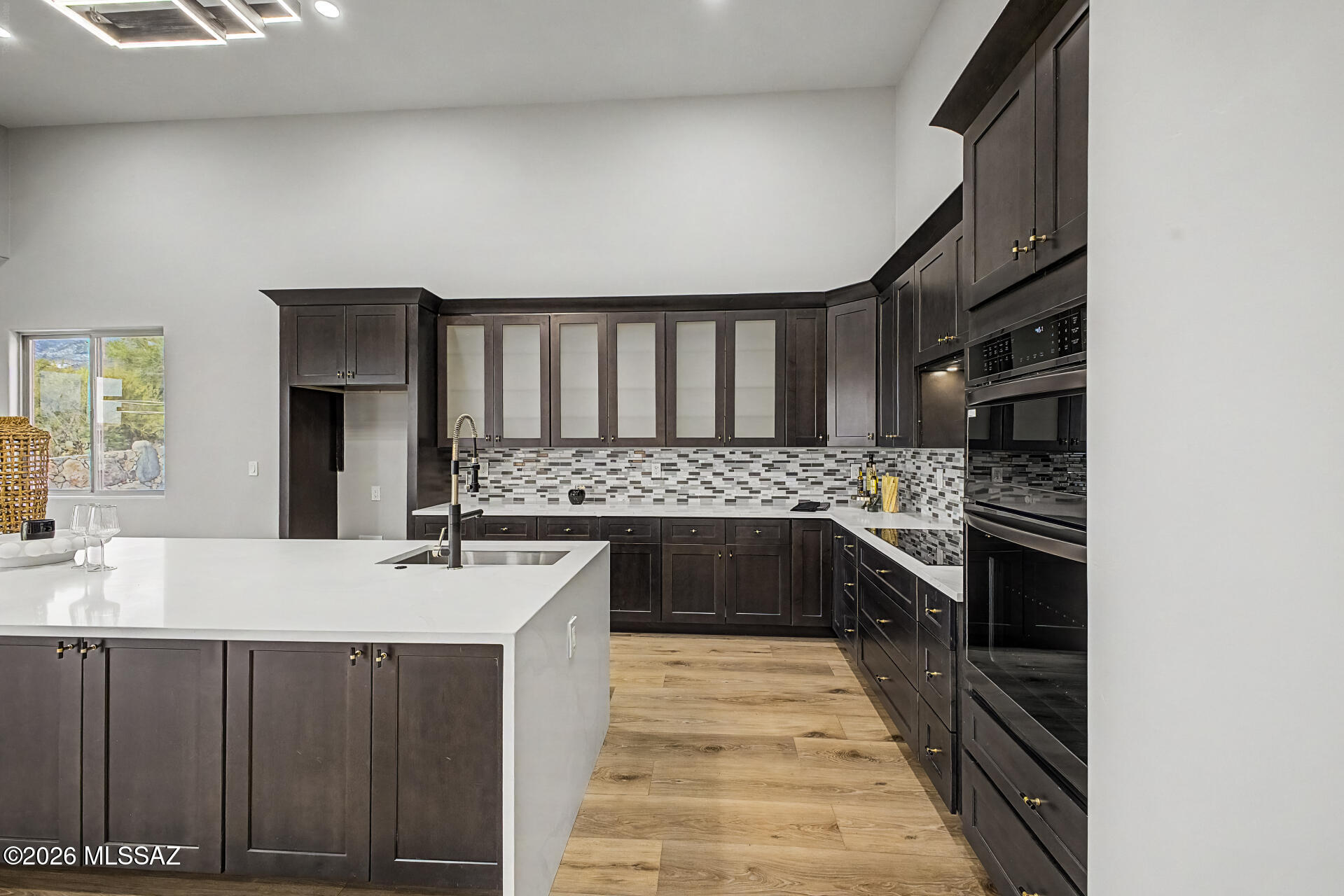 2399 Della Roccia Court Tucson, AZ 85737 - Photo 13 of 34 a kitchen with a sink stove and cabinets