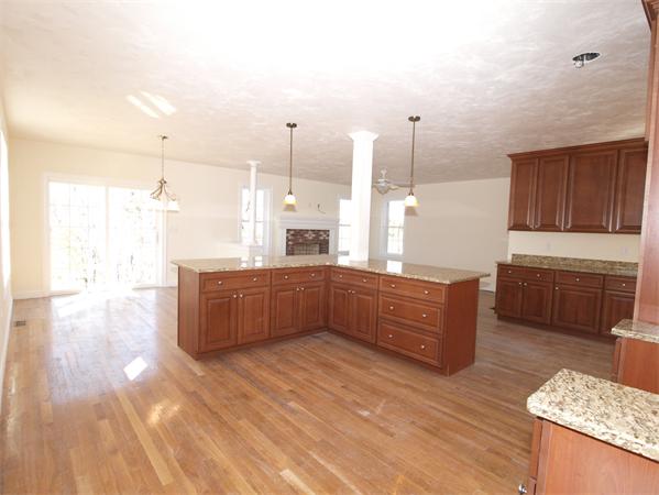 Lot 6 West Ledge Road Clinton, MA 01510 - Photo 4 of 19 a kitchen with stainless steel appliances kitchen island granite countertop a sink a counter space and cabinets