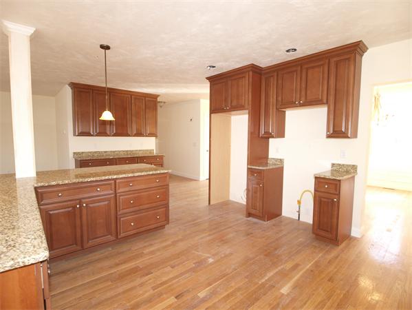 Lot 6 West Ledge Road Clinton, MA 01510 - Photo 6 of 19 a kitchen with stainless steel appliances granite countertop a refrigerator a sink dishwasher and wooden cabinets with wooden floor