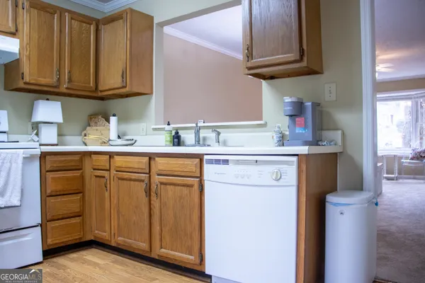 a kitchen with stainless steel appliances granite countertop a sink stove and cabinets