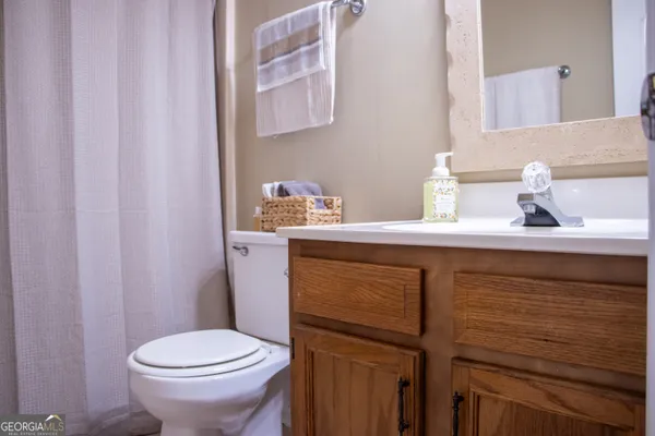 a bathroom with a sink a toilet and a mirror