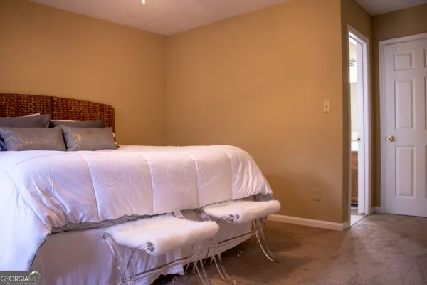 a bedroom with a bed and a chair