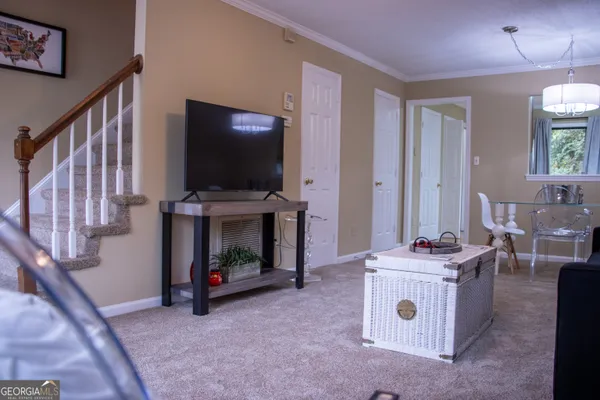 a living room with furniture and a flat screen tv