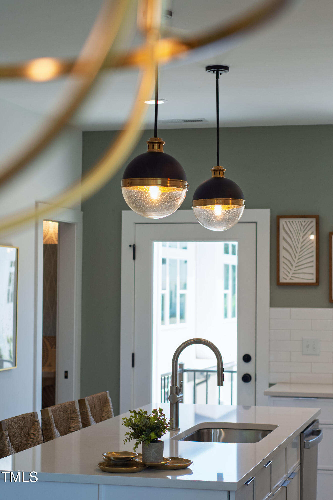 1313 Garner Road, Unit 101 Raleigh, NC 27610 - Photo 23 of 80 a kitchen with a faucet a chandelier and living room view