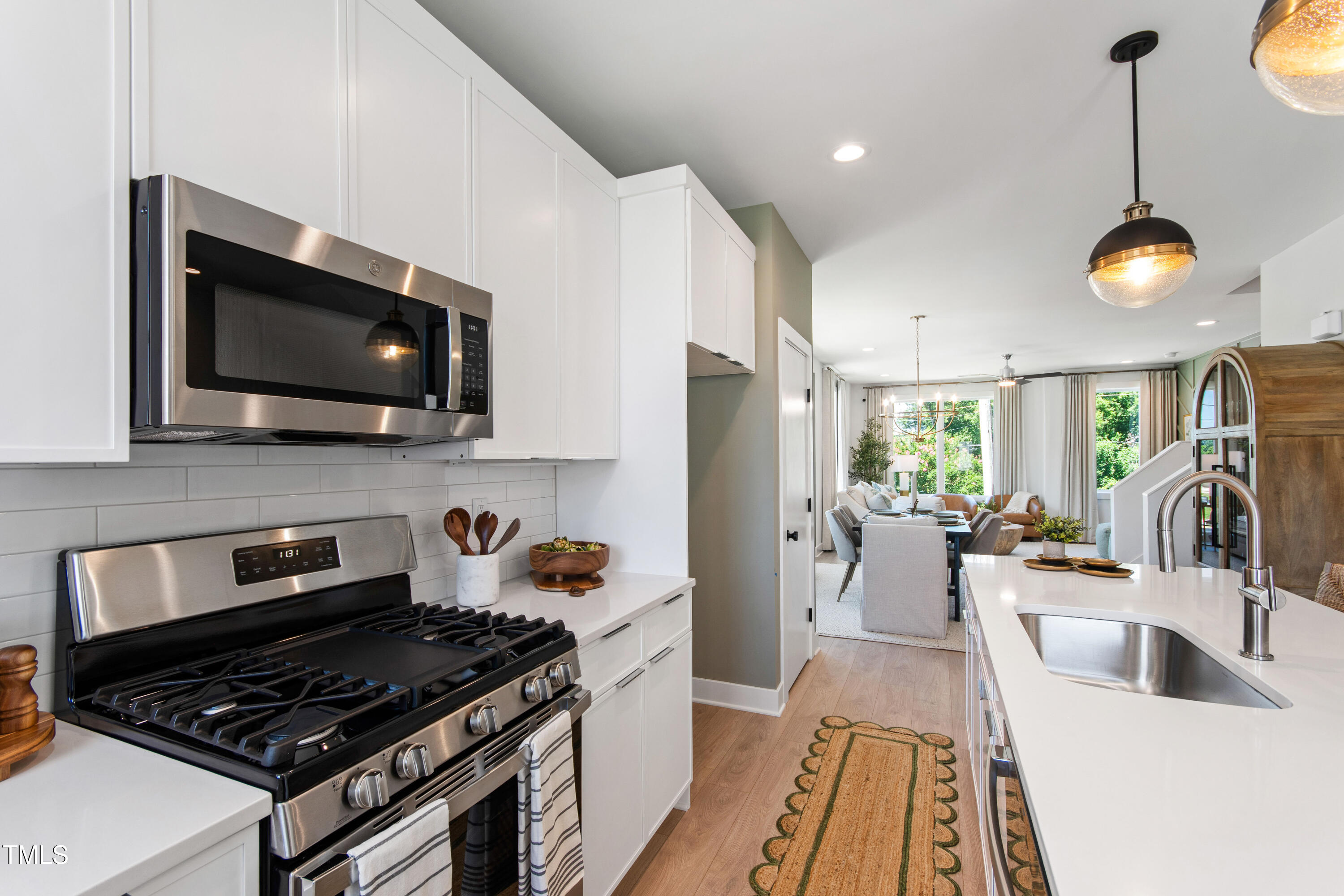 1313 Garner Road, Unit 101 Raleigh, NC 27610 - Photo 24 of 80 a kitchen with a stove and a wooden floor