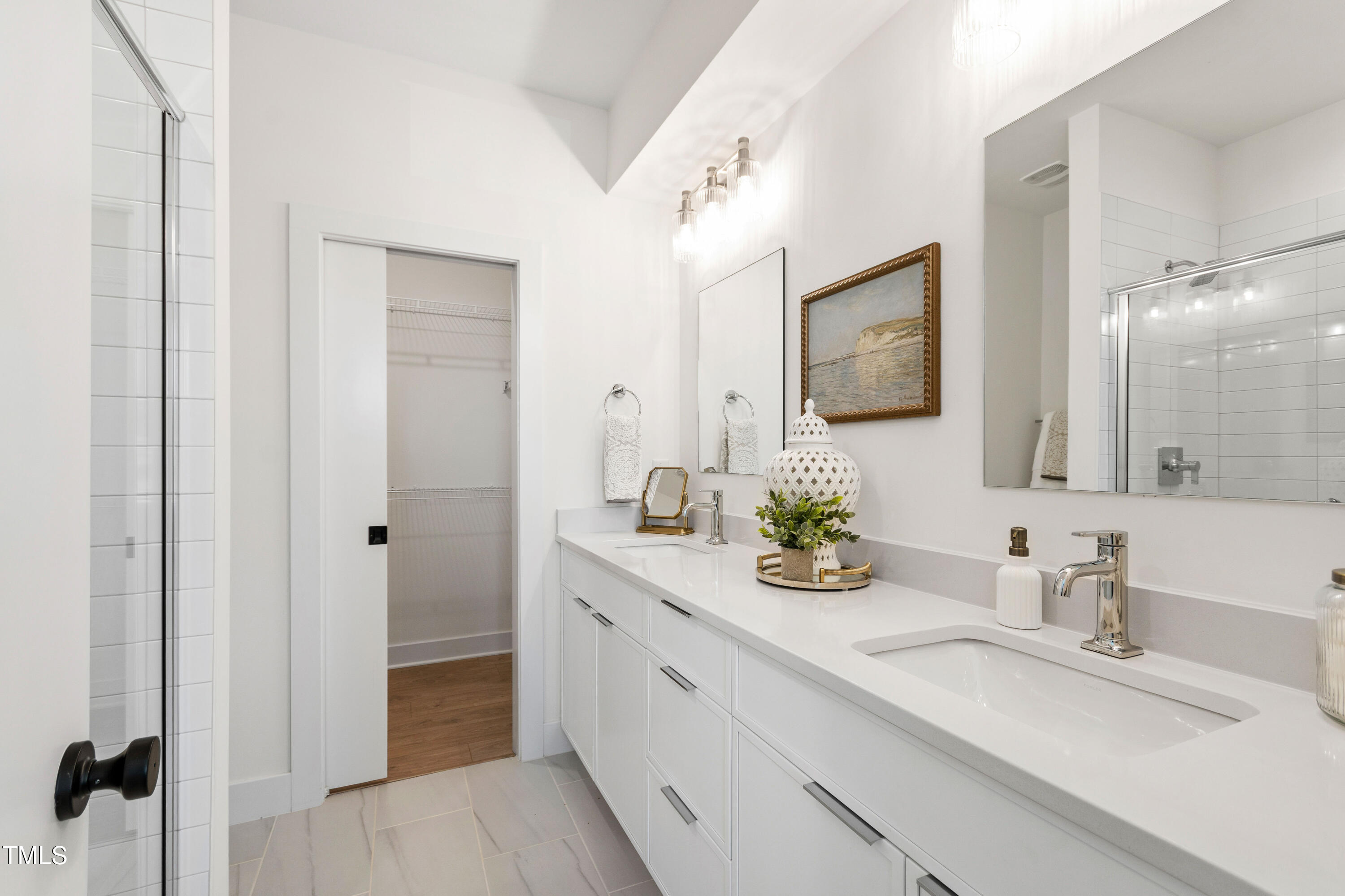1313 Garner Road, Unit 101 Raleigh, NC 27610 - Photo 48 of 80 a bathroom with a double vanity sink and mirror