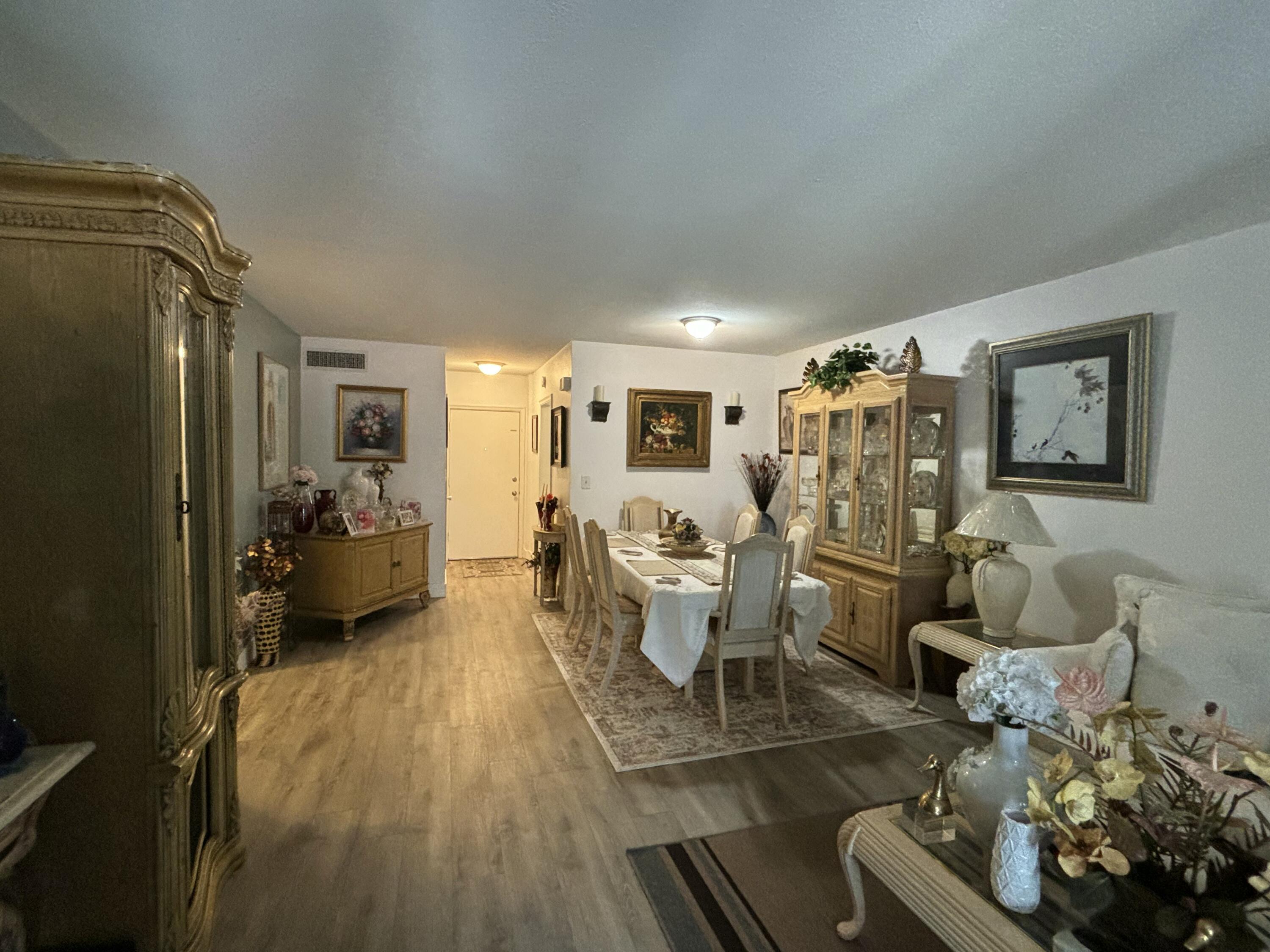 331 Southwest 8th Street, Unit 2CE Boca Raton, FL 33432 - Photo 5 of 19 a living room with furniture and a large window