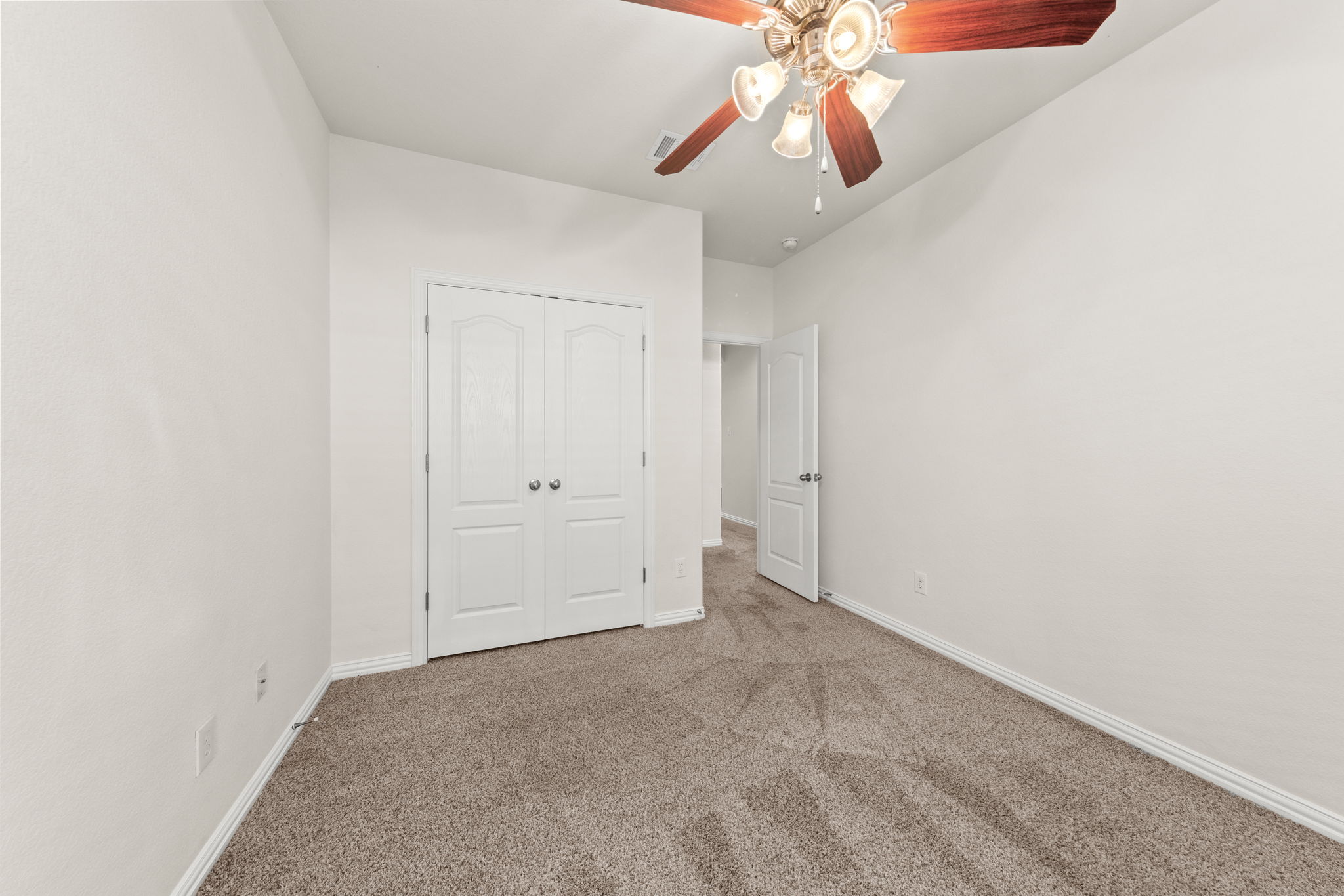 411 Tascate Street Georgetown, TX 78628 - Photo 32 of 41 A comfortable bedroom with plush carpet and a stylish ceiling fan provides a relaxing retreat.