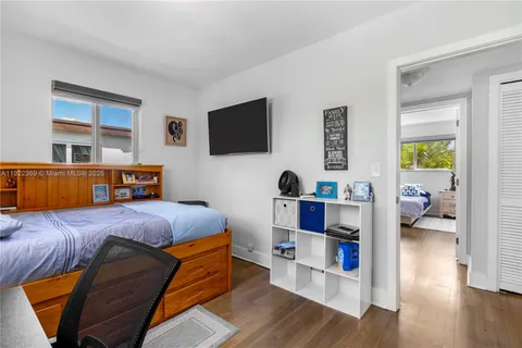 a bedroom with furniture and a flat screen tv