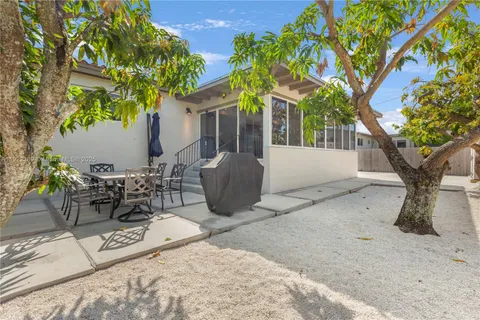 a view of a patio with table and chairs and potted plants
