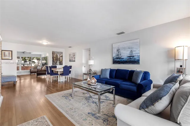 a living room with furniture or couch and a wooden floor