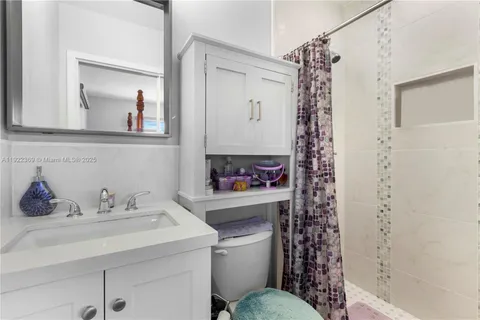 a bathroom with a sink toilet and shower