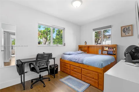 a bedroom with a bed and a desk