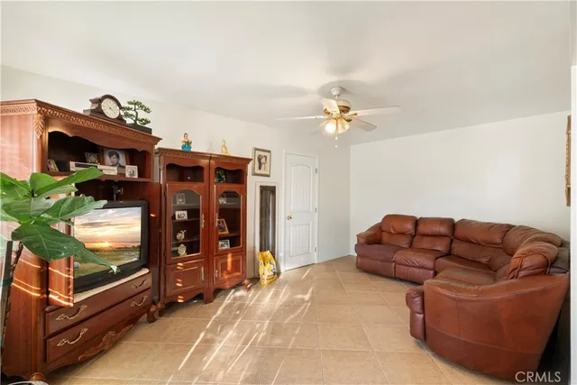 a living room with furniture a chandelier and a window