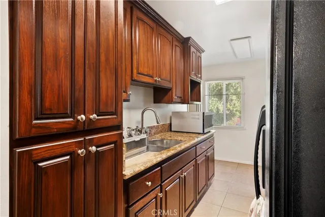 a kitchen with stainless steel appliances granite countertop a stove microwave and sink