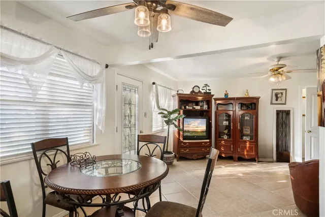 a view of a dining room with furniture and a chandelier fan