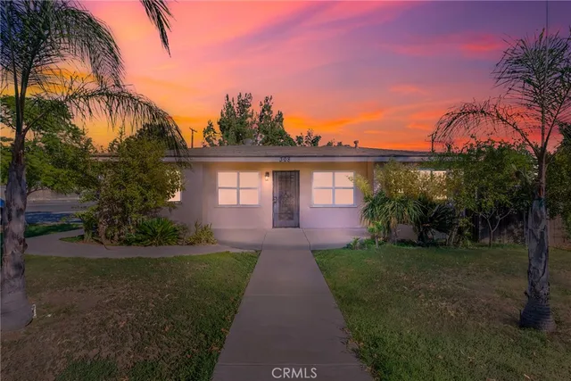 a front view of a house with yard and green space