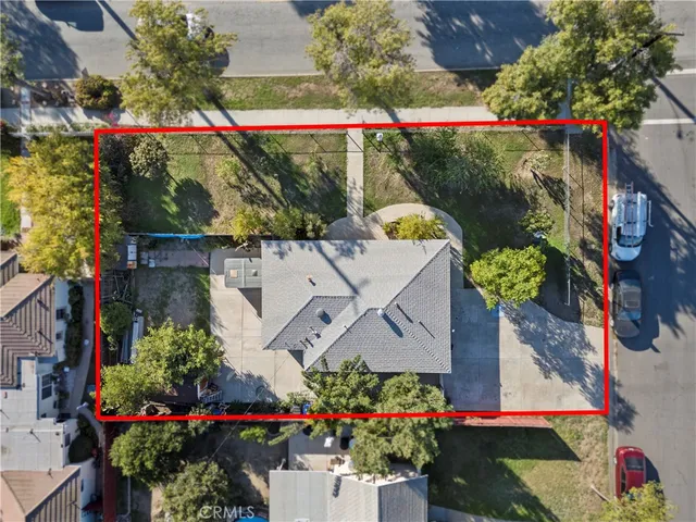 an aerial view of a house with a yard and a lot of lake view