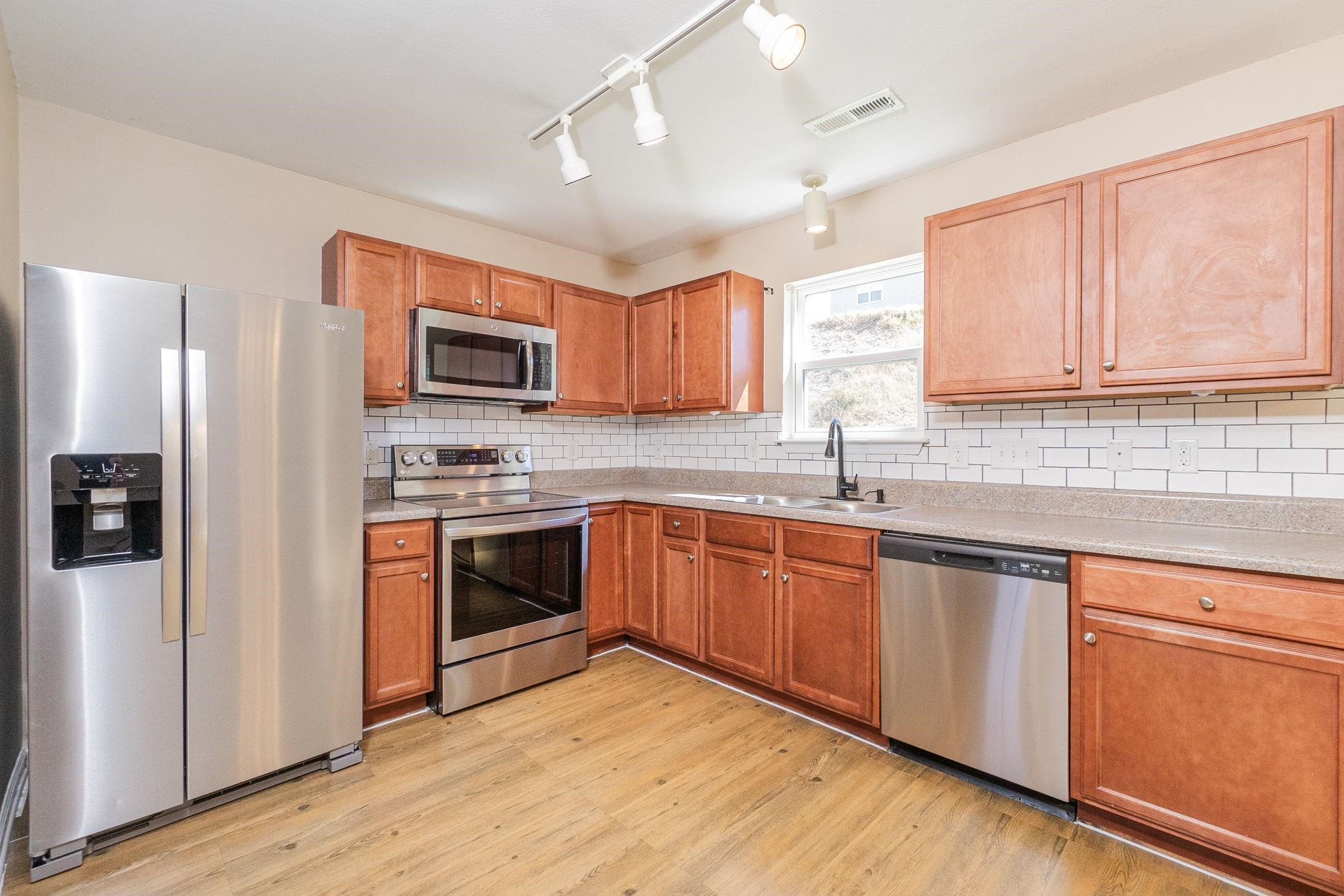 4816 Quarryman Road Raleigh, NC 27610 - Photo 5 of 25 New refrigerator, range and diswasher. Stainless steel appliances, tile backsplash, luxury vinyl plank floors Kitchen