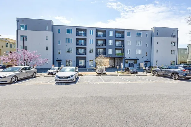 a view of a building and cars parked