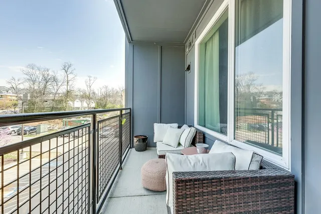 a bedroom with furniture and a large window