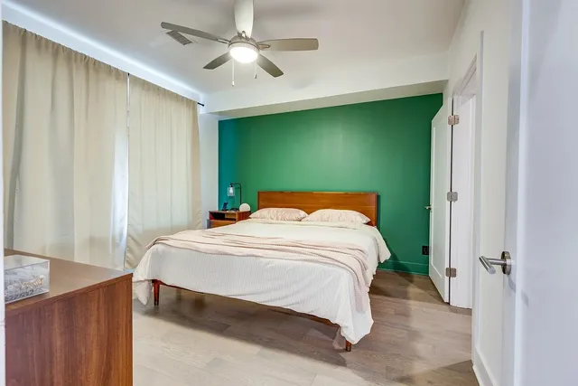 a bedroom with a bed and a chandelier