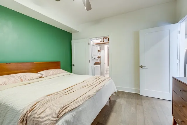 a bedroom with a bed and a dresser