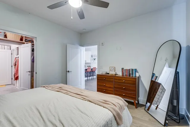 a bedroom with a bed and a chandelier
