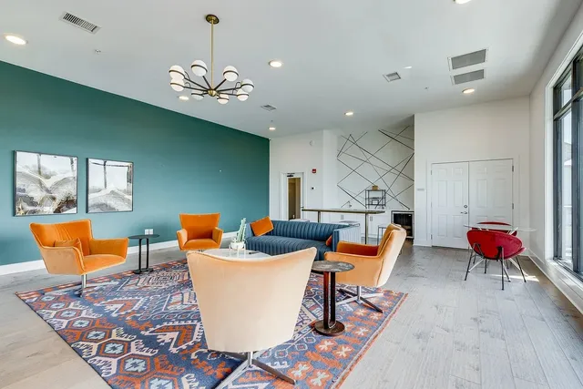 a living room with furniture a rug and a chandelier