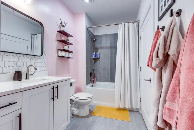a bathroom with a sink toilet and shower