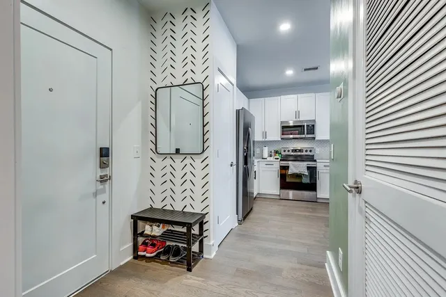 a kitchen with refrigerator and cabinets