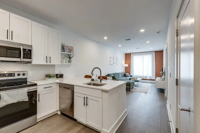 a kitchen with a sink stove and cabinets
