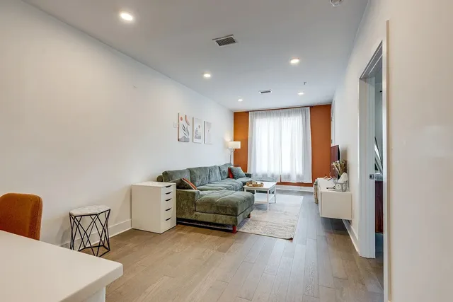 a living room with furniture and a large window