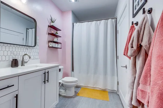 a bathroom with a sink toilet and shower