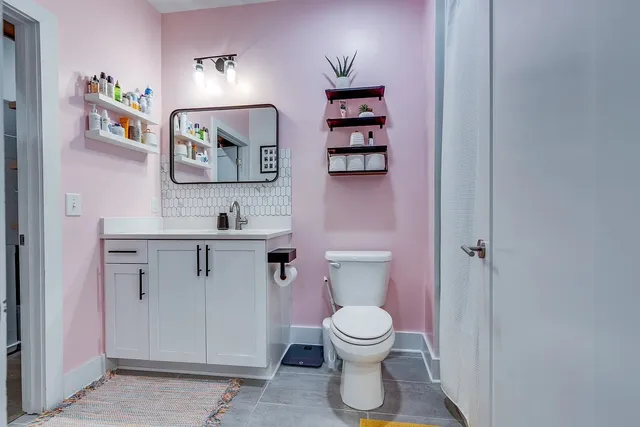 a white toilet sitting next to a bathroom sink