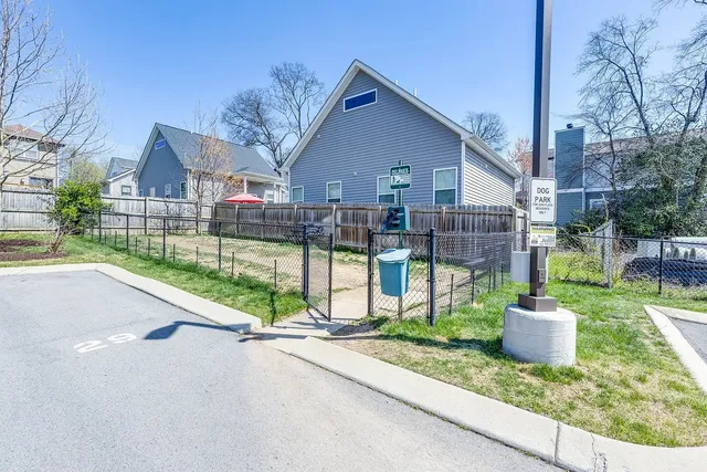 a view of a house with a yard and fence